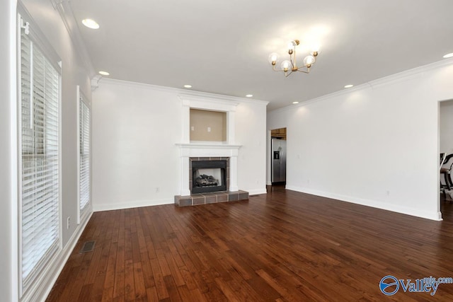 105 Patdean Dr, Huntsville, AL 35811 - unfurnished living room with crown molding, a chandelier, dark wood-style floors, a fireplace, and baseboards