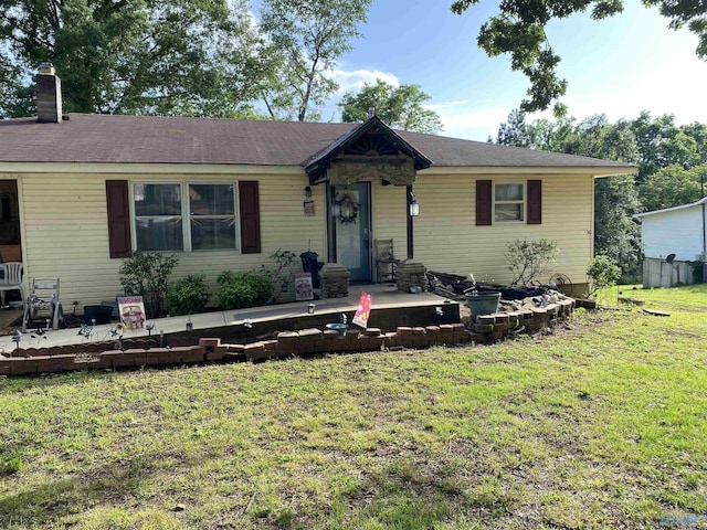 121 County Road 575, Rogersville, AL 35652 - view of front of property featuring a front yard, a chimney, and a patio area