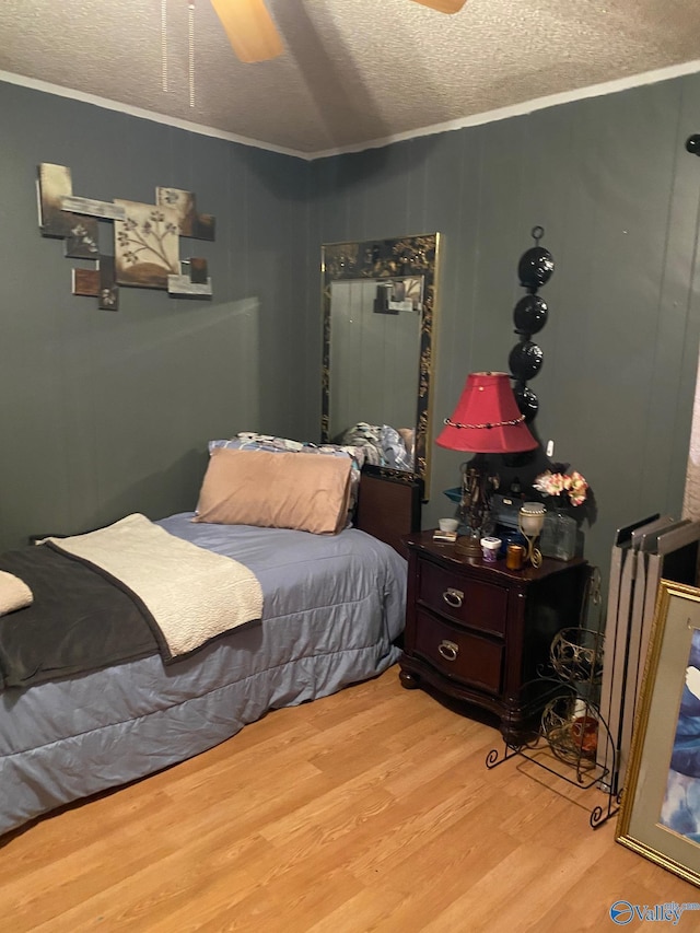 121 County Road 575, Rogersville, AL 35652 - bedroom featuring crown molding, light wood-type flooring, a textured ceiling, and a ceiling fan