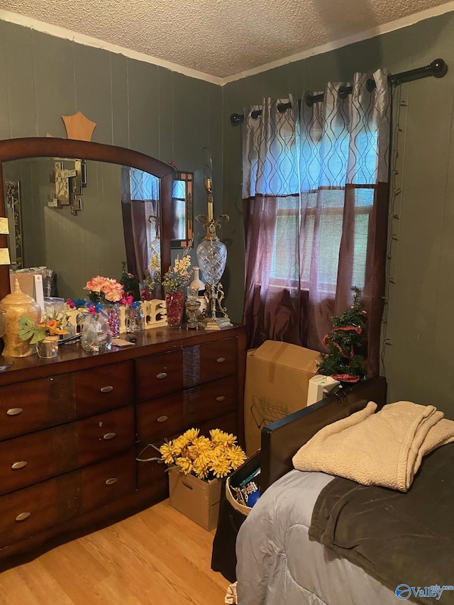 121 County Road 575, Rogersville, AL 35652 - bedroom featuring a textured ceiling and light wood-style floors