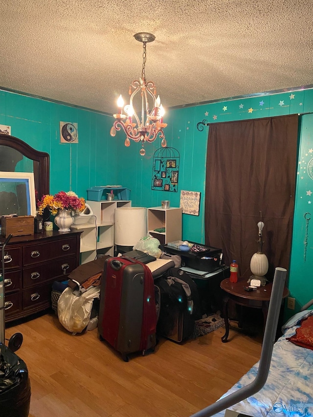 121 County Road 575, Rogersville, AL 35652 - bedroom featuring wood finished floors, a textured ceiling, and a chandelier