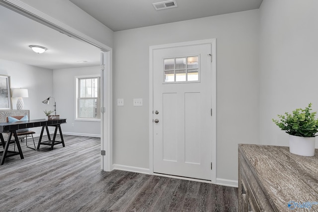 entryway with baseboards, visible vents, and wood finished floors