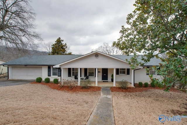 single story home with a garage and covered porch