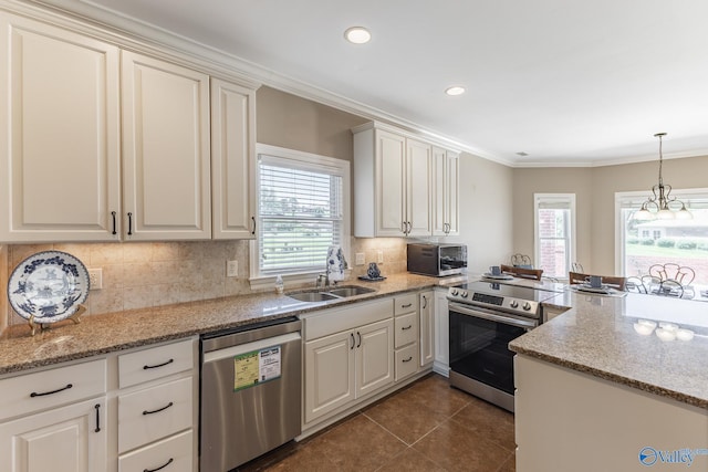 101 Tempo Cir, Harvest, AL 35749 - kitchen featuring appliances with stainless steel finishes, a sink, dark tile patterned floors, ornamental molding, and decorative backsplash
