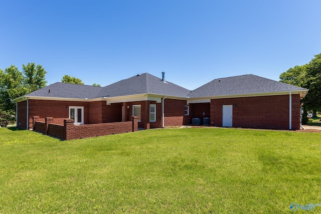 101 Tempo Cir, Harvest, AL 35749 - back of property with a yard, brick siding, a shingled roof, and central AC