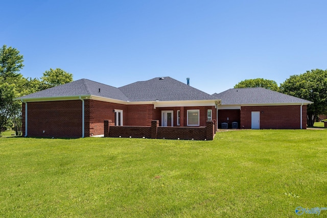 101 Tempo Cir, Harvest, AL 35749 - rear view of house with a lawn, brick siding, and a shingled roof