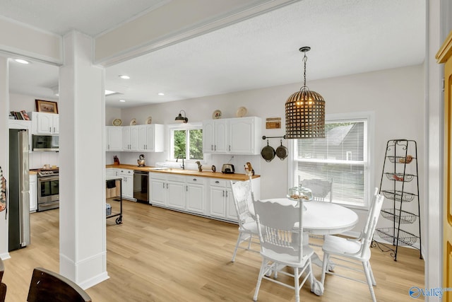 dining room featuring recessed lighting and light wood-style flooring