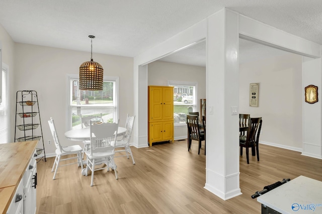 dining room with light wood-style flooring and baseboards
