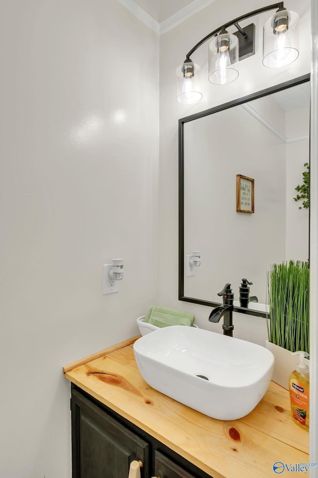 bathroom with vanity and ornamental molding