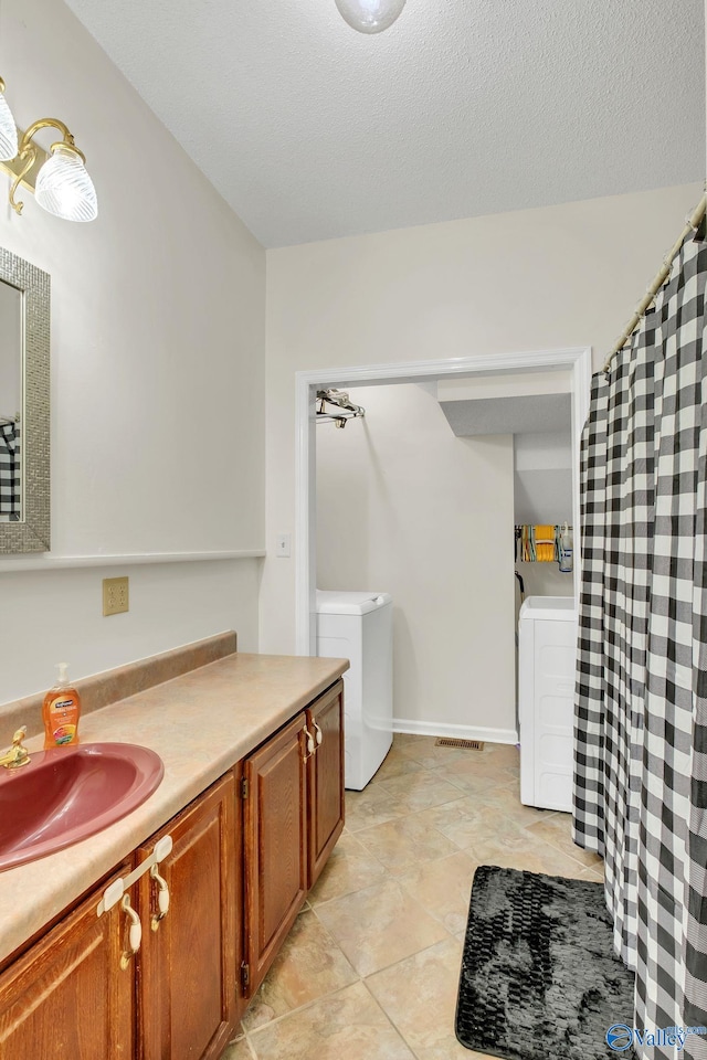 full bathroom with vanity, tile patterned floors, visible vents, washer and dryer, and a shower with shower curtain