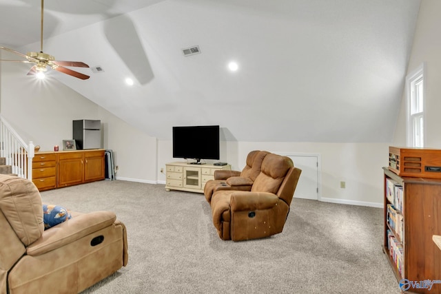 living room featuring visible vents, light carpet, ceiling fan, and vaulted ceiling