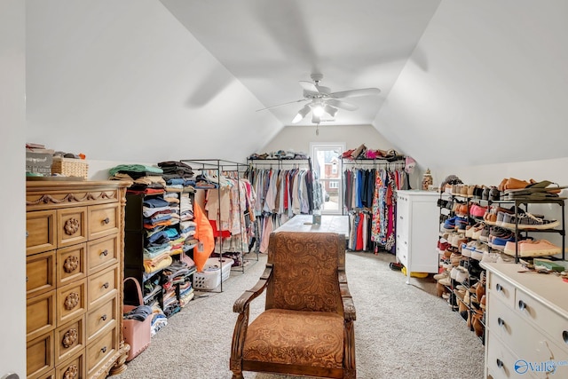 walk in closet featuring light carpet, ceiling fan, and vaulted ceiling