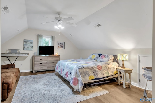 bedroom with visible vents, wood finished floors, ceiling fan, and lofted ceiling