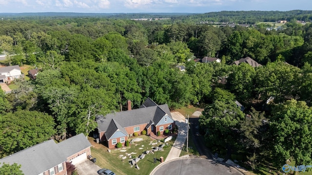 drone / aerial view featuring a view of trees
