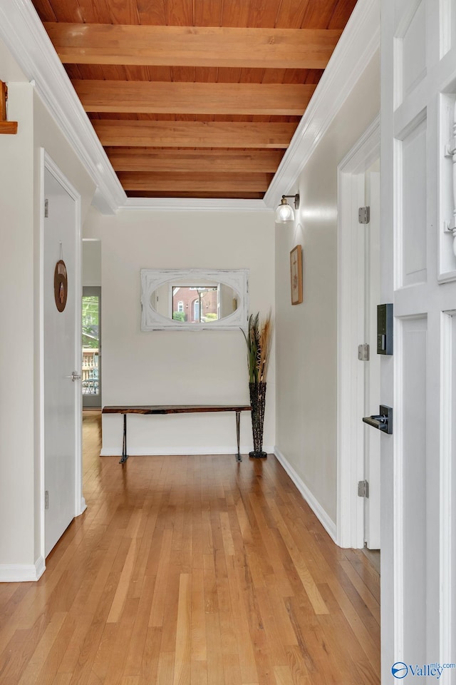 hallway featuring light wood finished floors, wooden ceiling, and beam ceiling