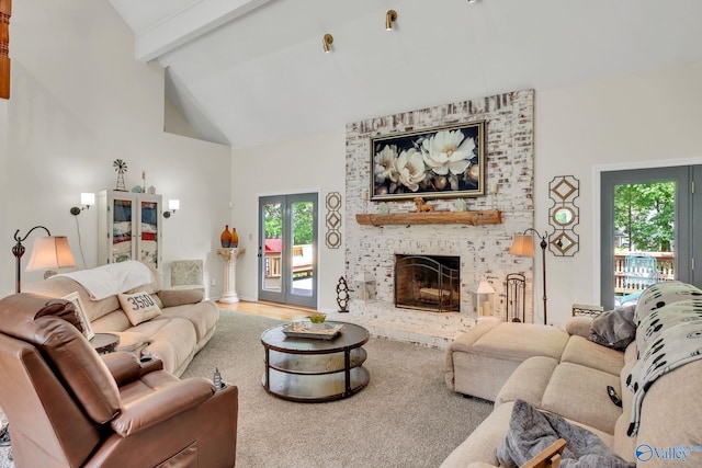 living room featuring a fireplace, a healthy amount of sunlight, high vaulted ceiling, and beamed ceiling