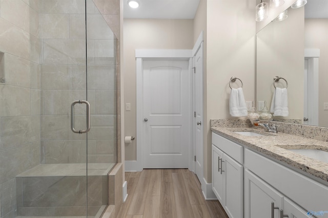 413 Lando Cain Rd, Hartselle, AL 35640 - bathroom featuring a shower stall, wood finished floors, double vanity, recessed lighting, and baseboards