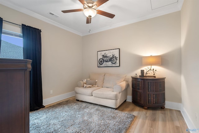 413 Lando Cain Rd, Hartselle, AL 35640 - living area with wood finished floors, ceiling fan, crown molding, and baseboards