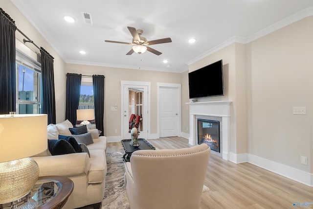 413 Lando Cain Rd, Hartselle, AL 35640 - living room with ceiling fan, light wood finished floors, a glass covered fireplace, baseboards, and ornamental molding