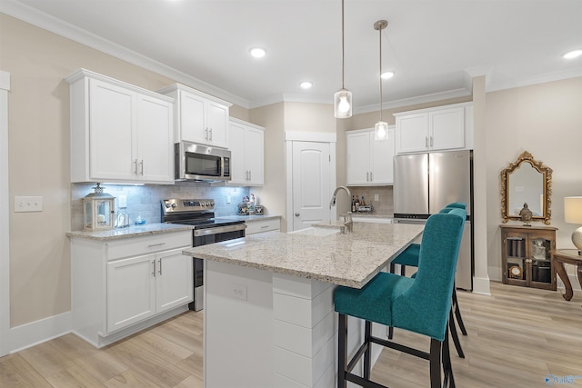 413 Lando Cain Rd, Hartselle, AL 35640 - kitchen with appliances with stainless steel finishes, a sink, light wood-type flooring, white cabinetry, and tasteful backsplash