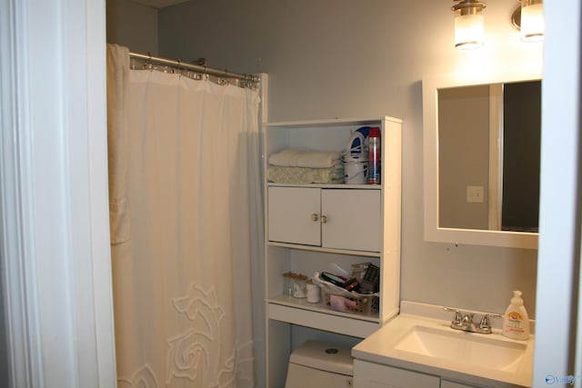 bathroom with vanity, toilet, and walk in shower
