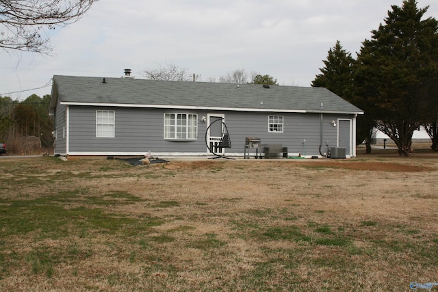 rear view of house featuring a patio, a yard, and cooling unit