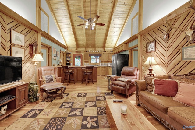 living room featuring wood ceiling, high vaulted ceiling, wood walls, light hardwood / wood-style floors, and beamed ceiling