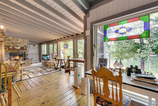 sunroom with a fireplace and lofted ceiling with beams