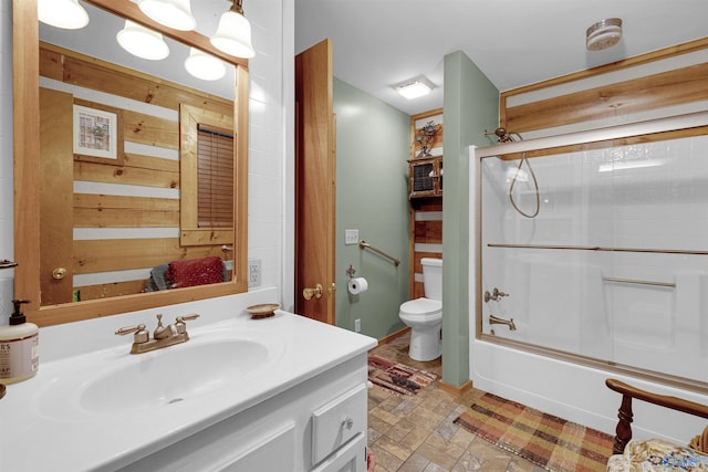 full bathroom featuring enclosed tub / shower combo, toilet, vanity, and tile patterned floors