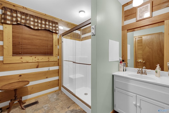 bathroom featuring tile patterned flooring, an enclosed shower, and vanity