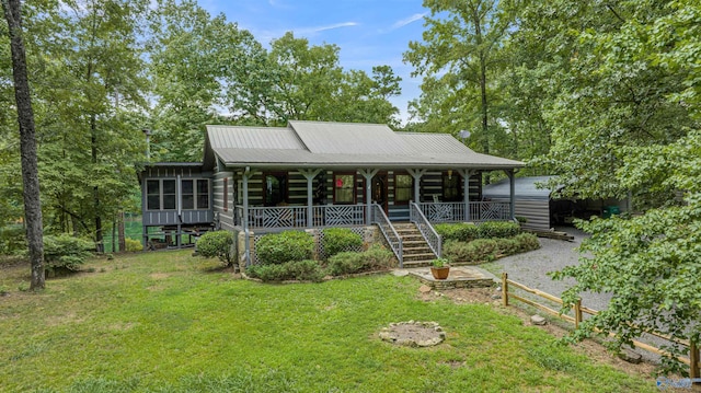 log-style house featuring covered porch and a front lawn