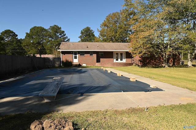 view of swimming pool with a yard, entry steps, and fence