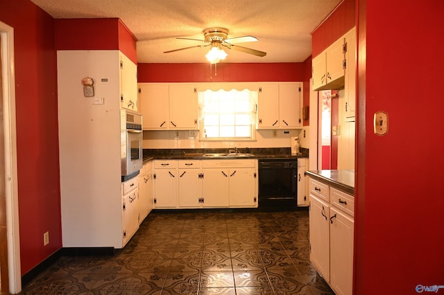 kitchen featuring oven, a sink, white cabinets, black dishwasher, and dark countertops