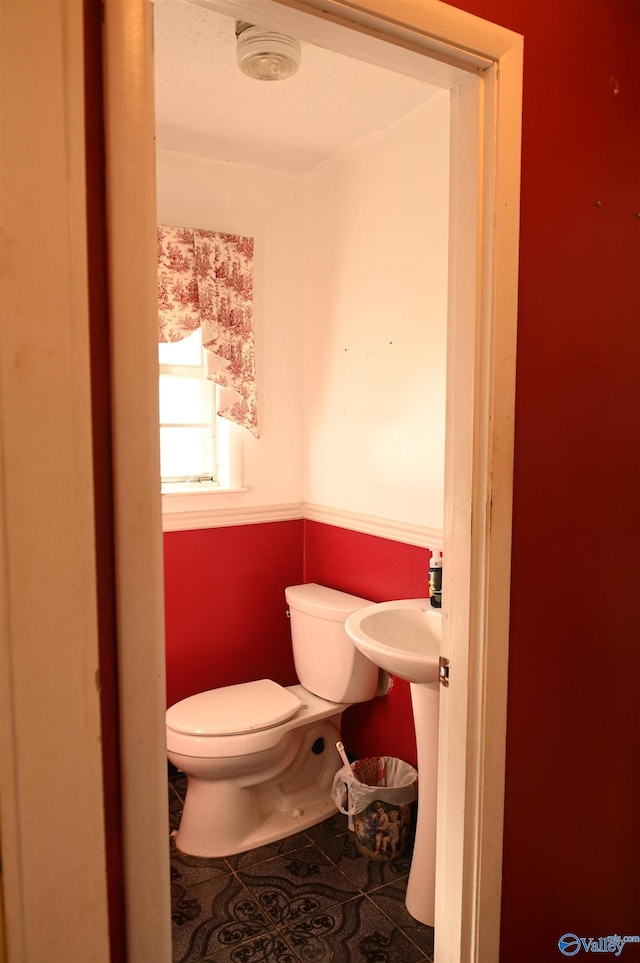 bathroom featuring tile patterned flooring and toilet