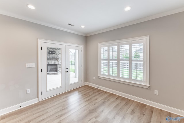 interior space featuring crown molding, light hardwood / wood-style floors, and french doors