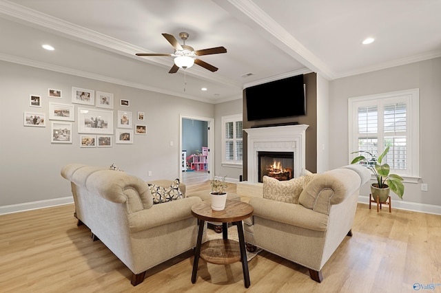 living room featuring crown molding, ceiling fan, and light hardwood / wood-style flooring