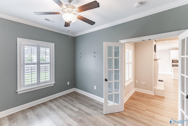 unfurnished room featuring ornamental molding, light hardwood / wood-style floors, and french doors