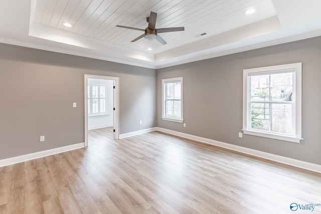 unfurnished room with a tray ceiling, ornamental molding, and wooden ceiling