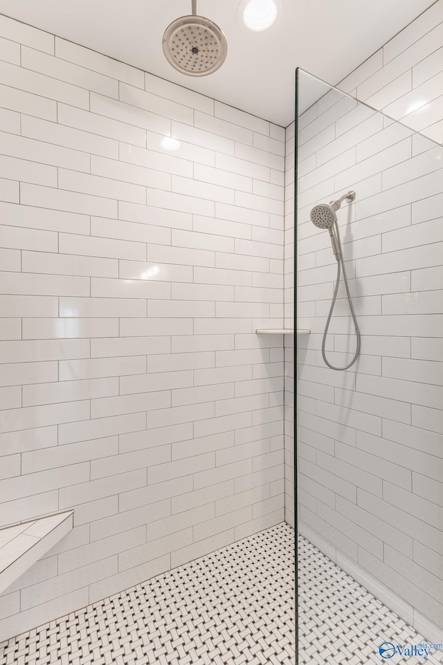 bathroom with a tile shower