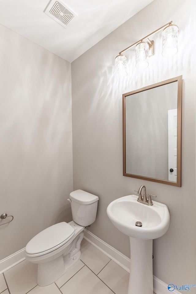 bathroom featuring tile patterned floors, toilet, and sink