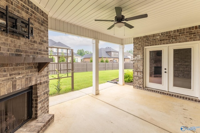 view of patio / terrace with an outdoor brick fireplace, ceiling fan, and french doors