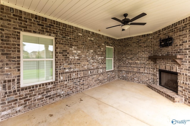 view of patio featuring an outdoor brick fireplace and ceiling fan