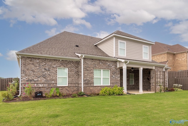 rear view of house with a yard and a patio area