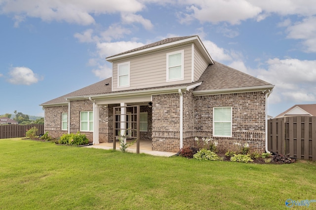 rear view of house featuring a patio and a lawn