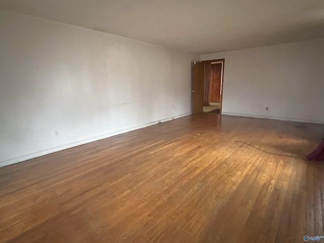 empty room featuring wood-type flooring