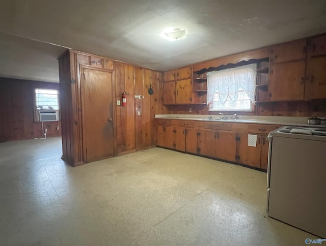 kitchen with cooling unit, wooden walls, and white stove