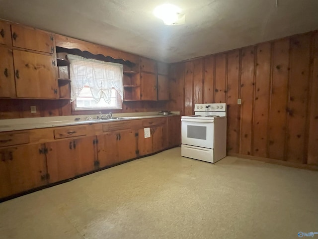 kitchen featuring sink, wooden walls, and white range with electric stovetop