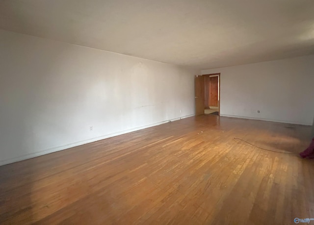 empty room with wood-type flooring