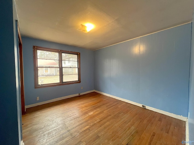 unfurnished room featuring wood-type flooring