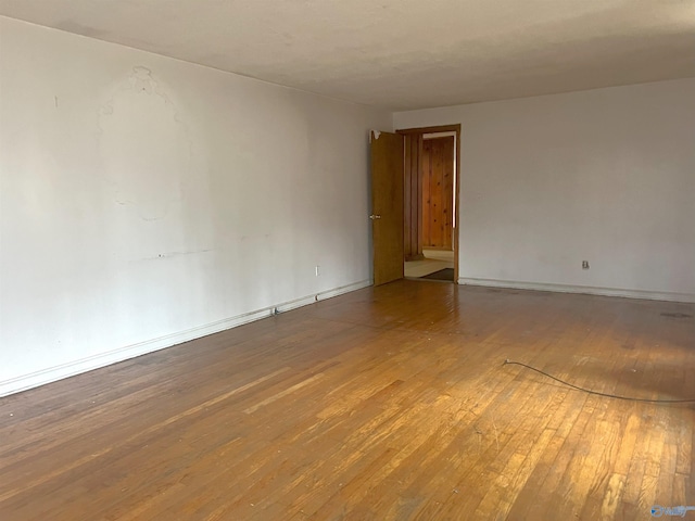 spare room with hardwood / wood-style flooring